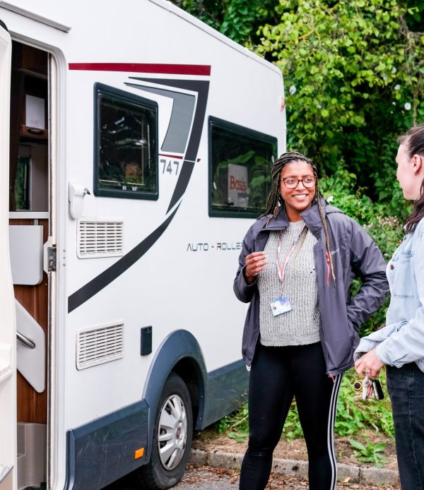 two women talking outside campervan